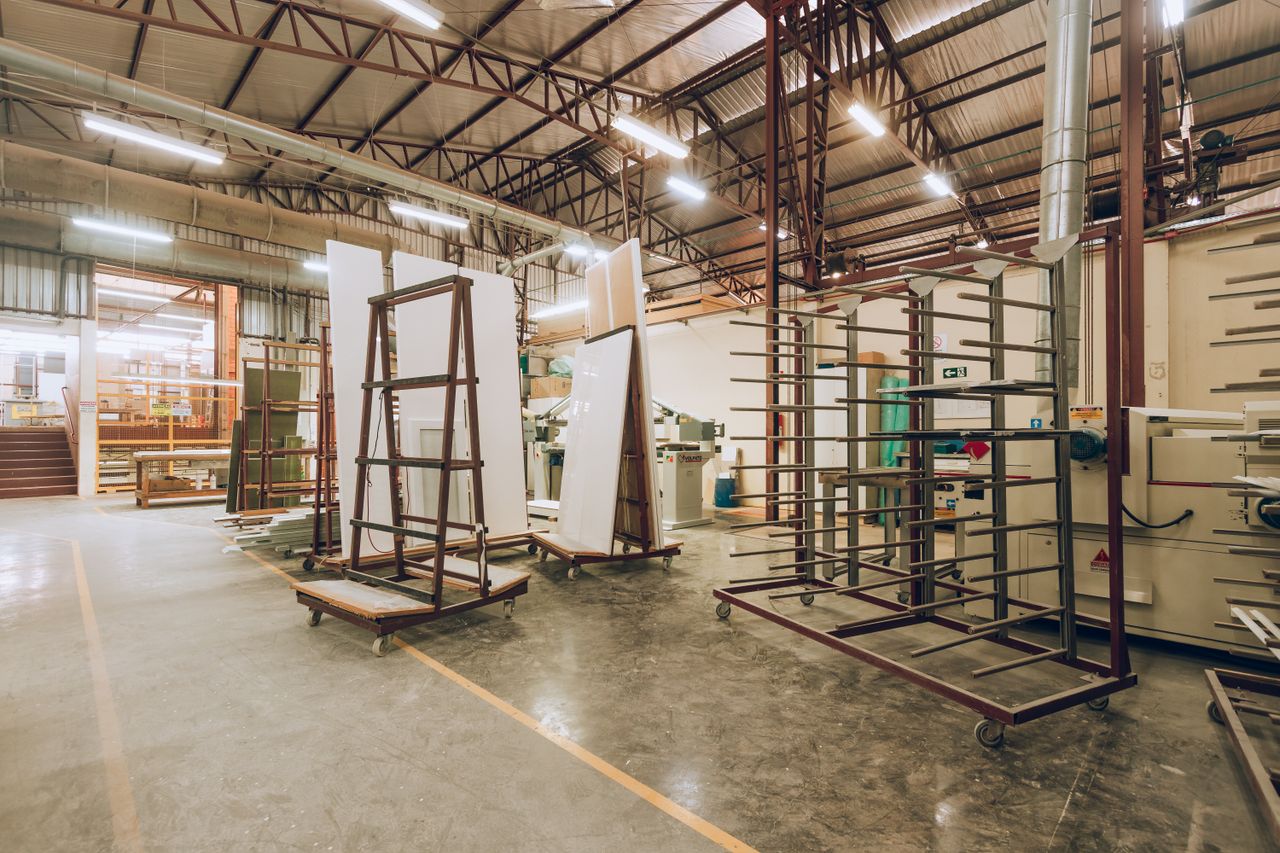 The Art of Drawing Readers In: Your attractive post title goes here A large, well-lit industrial factory interior showcasing machinery and storage solutions.